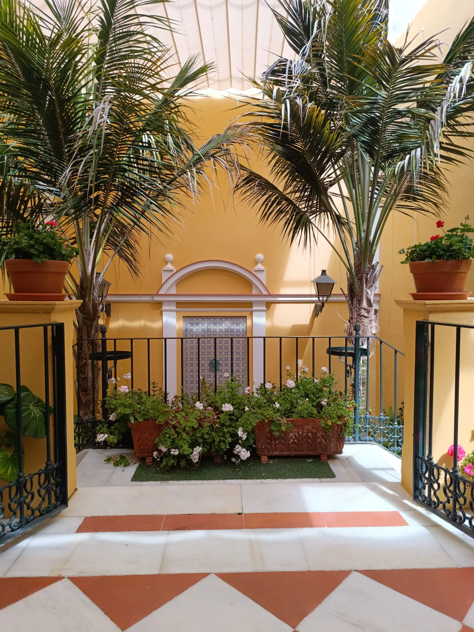Palm courtyard entrance with layered plantings at a commercial property