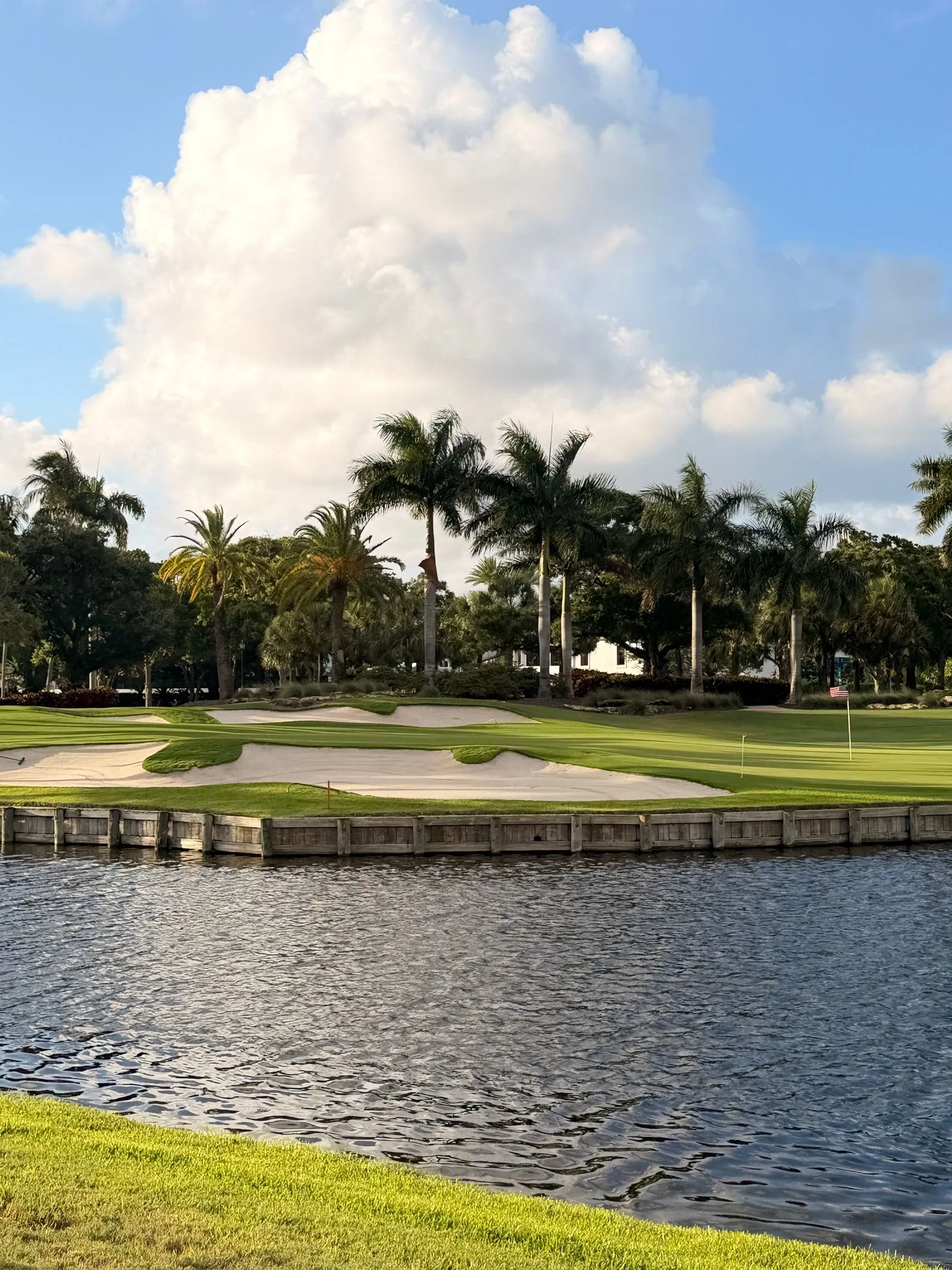 Palm-lined South Florida golf course with maintained turf and water features